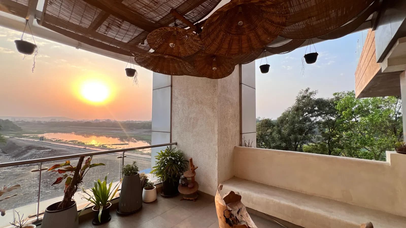 Wide view from the balcony at Mindsight Clinic, Boat Club Road, Pune, across the river and trees at sunset