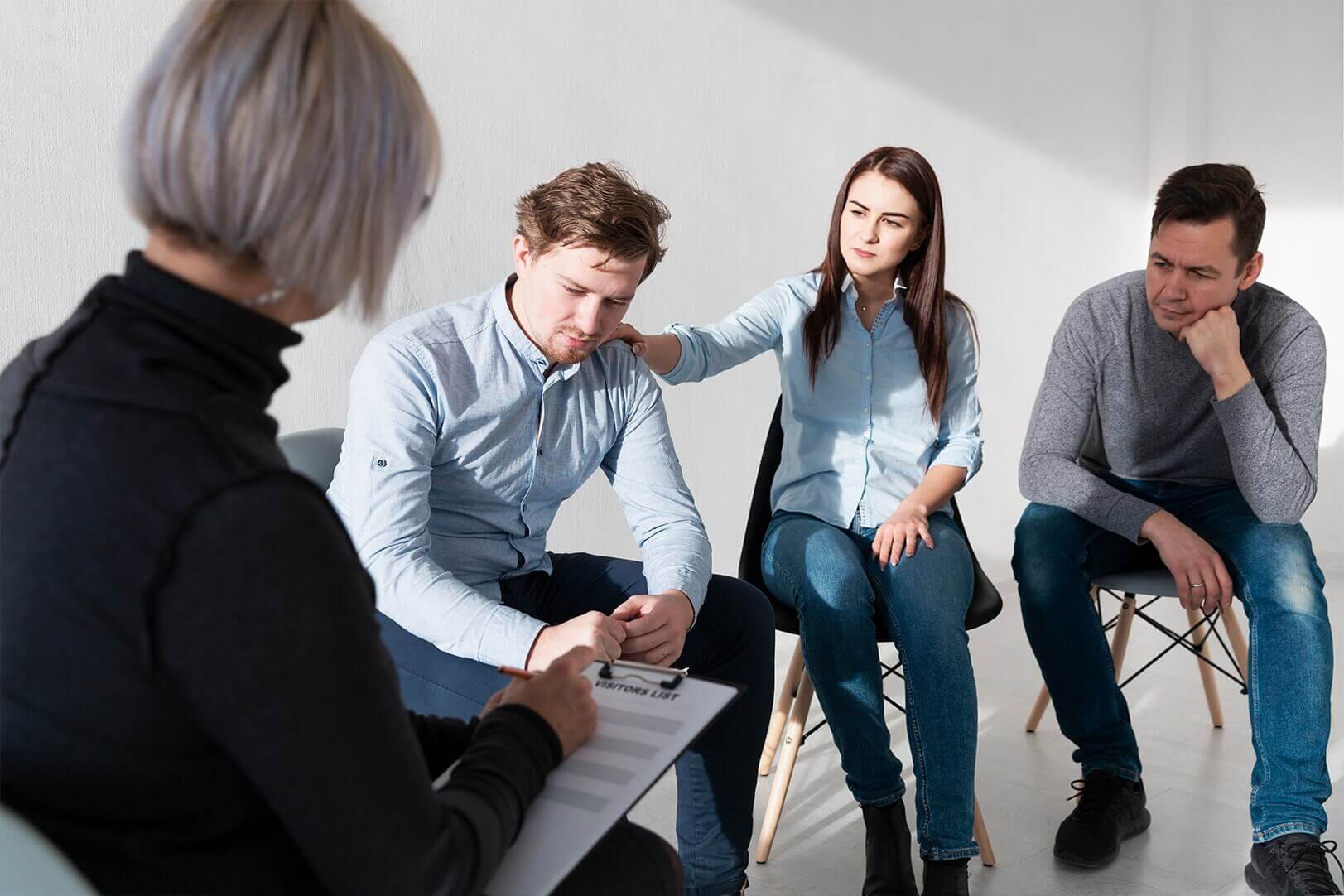 Psychologist from Mindsight Clinic conducting de - addiction therapy with a group of patients making them understand what is addiction ?  and the types of addiction