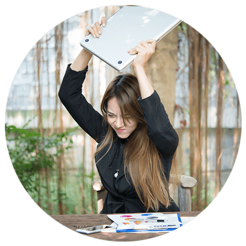 Woman throwing a laptop on the ground because of constant frustration leading to serious anger management issues.